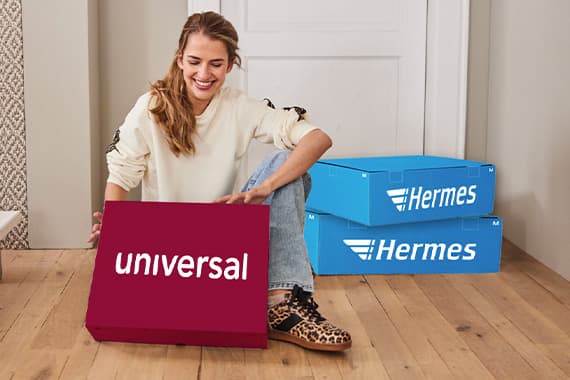 Frau sitzt auf dem Boden und hält ein Paket mit der Aufschrift "Universal". Daneben zwei blaue Hermes-Pakete.